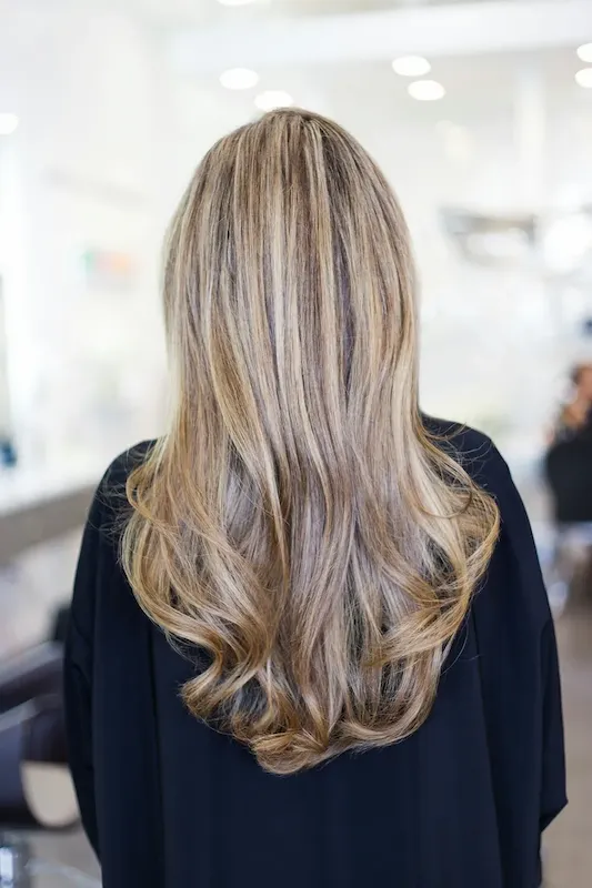 Image of long blonde hair from the back.